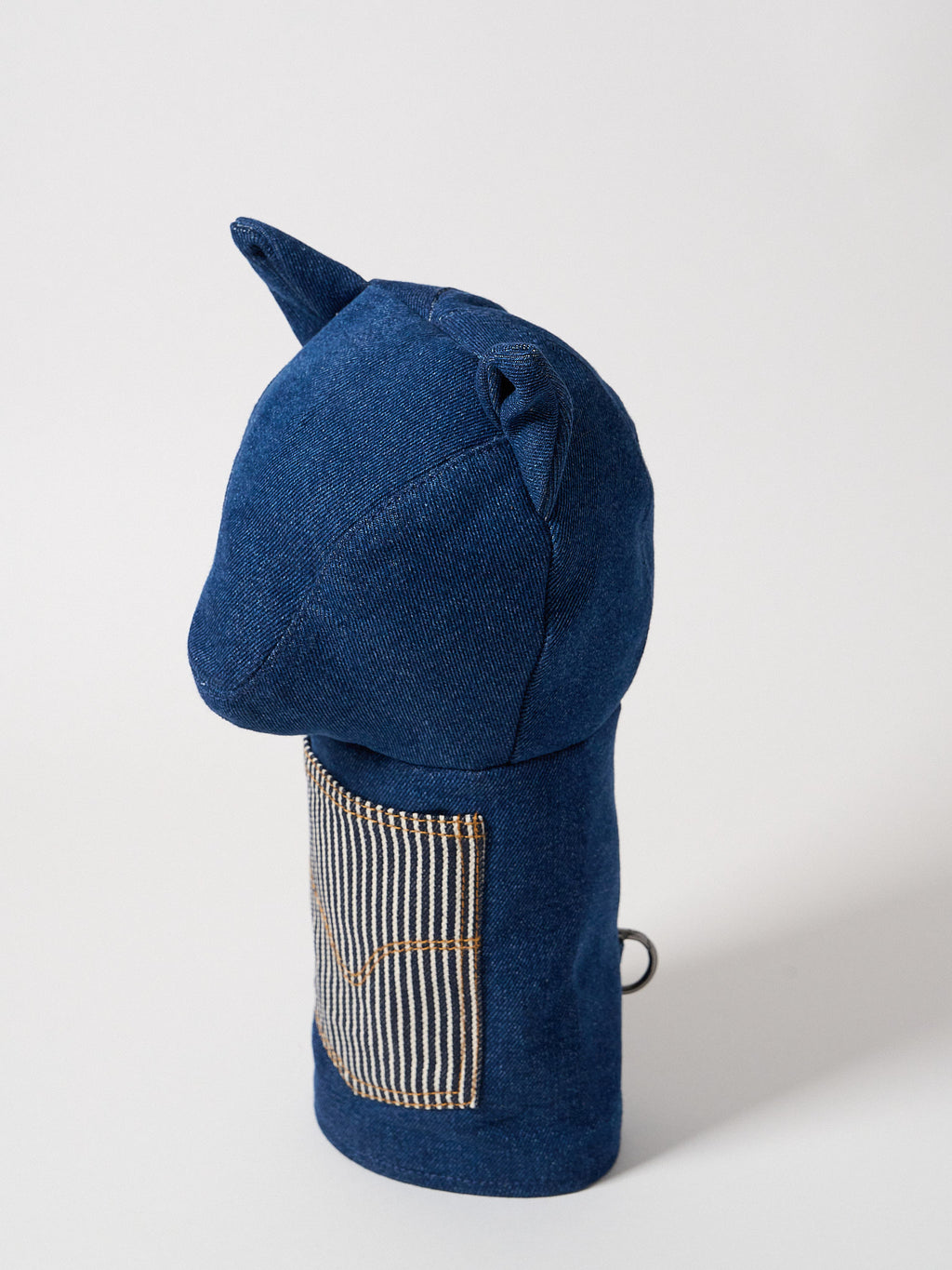 Profile view of a premium heavy-weight indigo denim driver headcover featuring artisanal top-stitching and a functional front utility pocket.