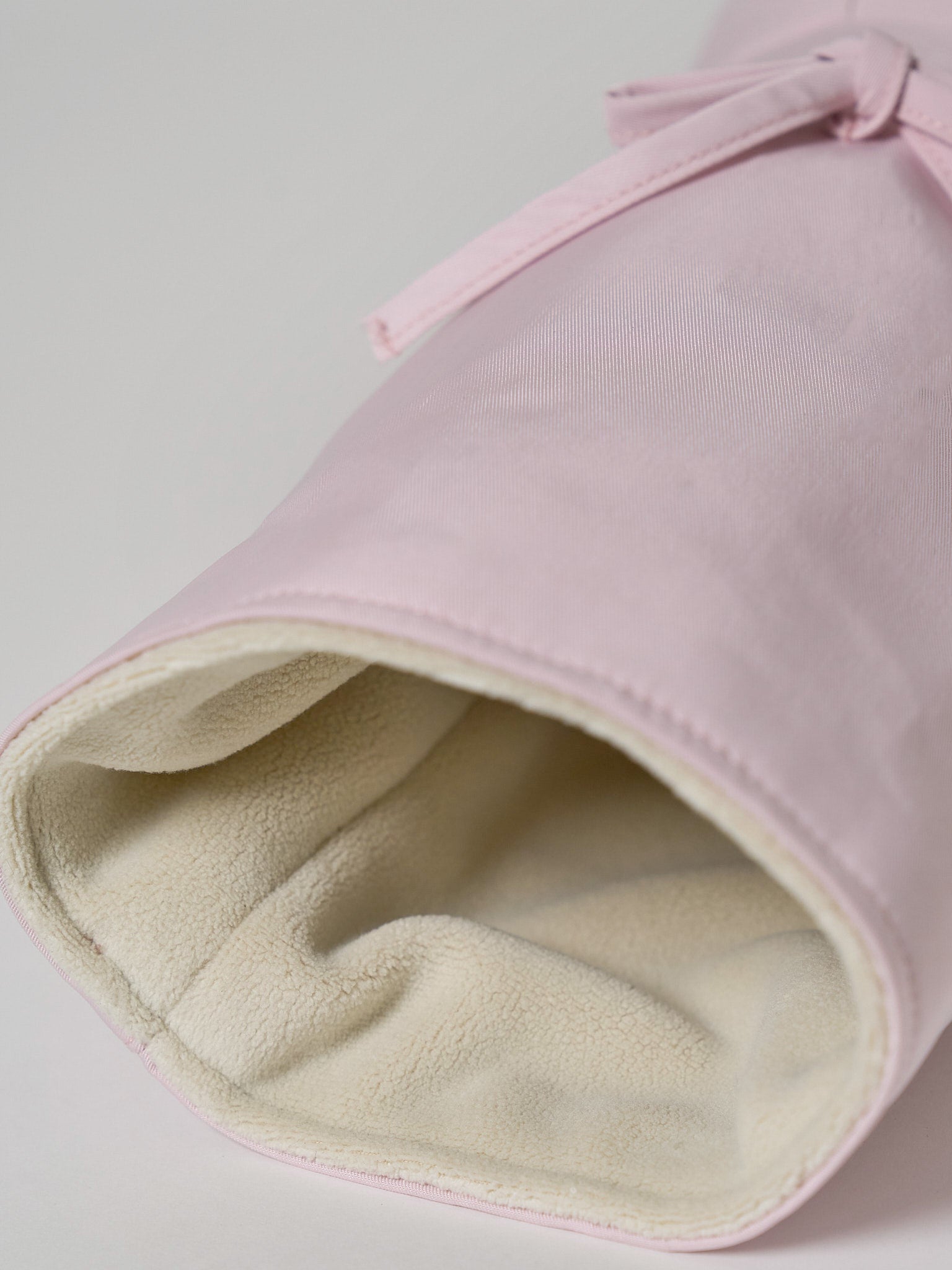 A high-performance golf driver headcover made from smooth, satin-textured nylon fabric with two playful pink ribbons sewn onto the front.