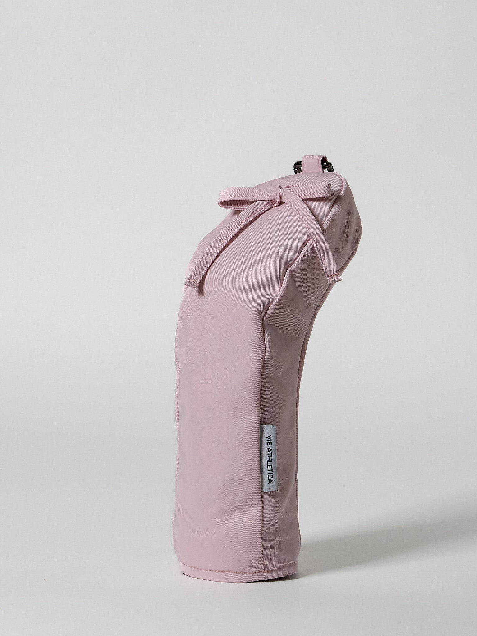 Structured pink nylon golf hybrid headcover featuring a decorative ribbon accent and a solid brass D-ring buckle.
