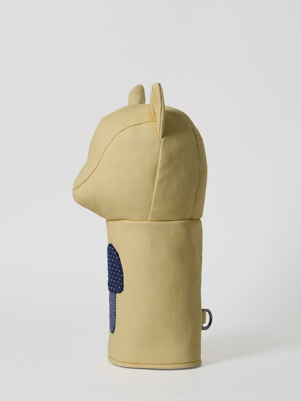 A structured golf driver headcover made from vibrant yellow denim, detailed with a playful mushroom patchwork design crafted from dark indigo denim.
